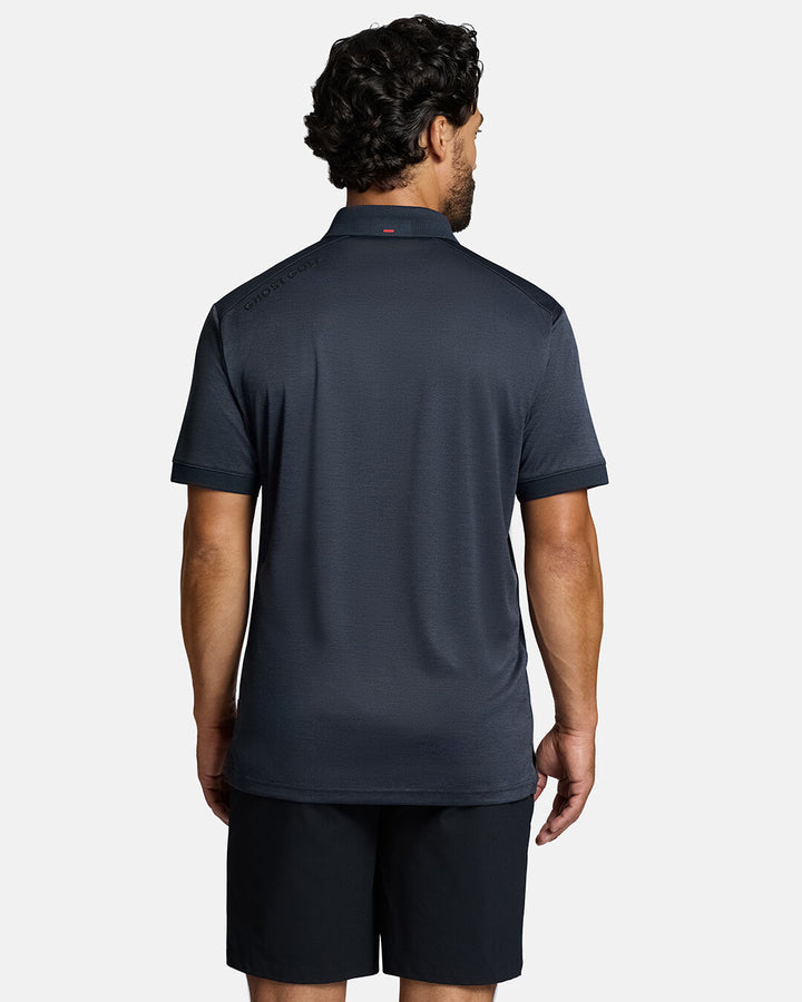 Top Back Body Shot of White Male Model Wearing Dark Navy Marled Core Polo with black shorts. Ghost Golf Hit on back left shoulder #color_dark-navy