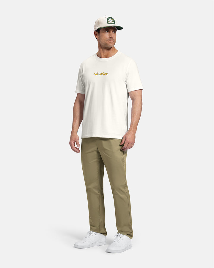 Full Body Front View of White Patrons Azalea Badge Tee on white male model wearing beige pants and white shoes and hat #color_white