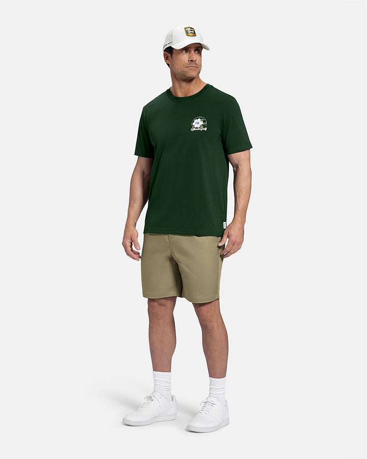 Full Body Front View of Bogey Green Patrons Azalea Tee on white male model wearing beige shorts and white shoes and hat #color_bogey-green