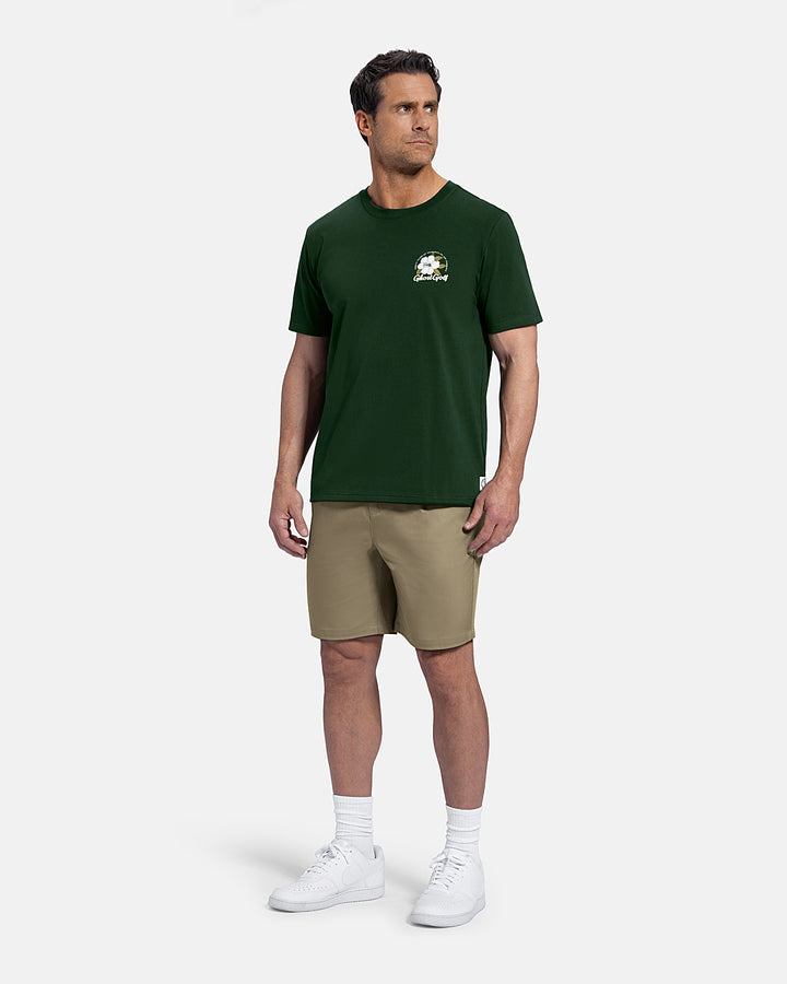 Full Body Front View of Bogey Green Patrons Azalea Tee on white male model wearing beige shorts and white shoes  #color_bogey-green