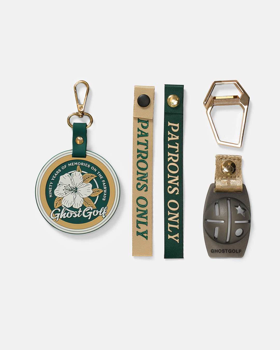 Product Shot of Golf Bag Accessories including ghost golf badge keychain carabiner and 2 patrons only pull tags and ball marker 