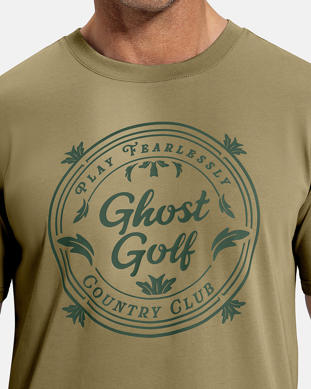 Closeup Front View of Sand Patrons Club Badge Tee on white male model showing ghost golf graphic hit #color_sand