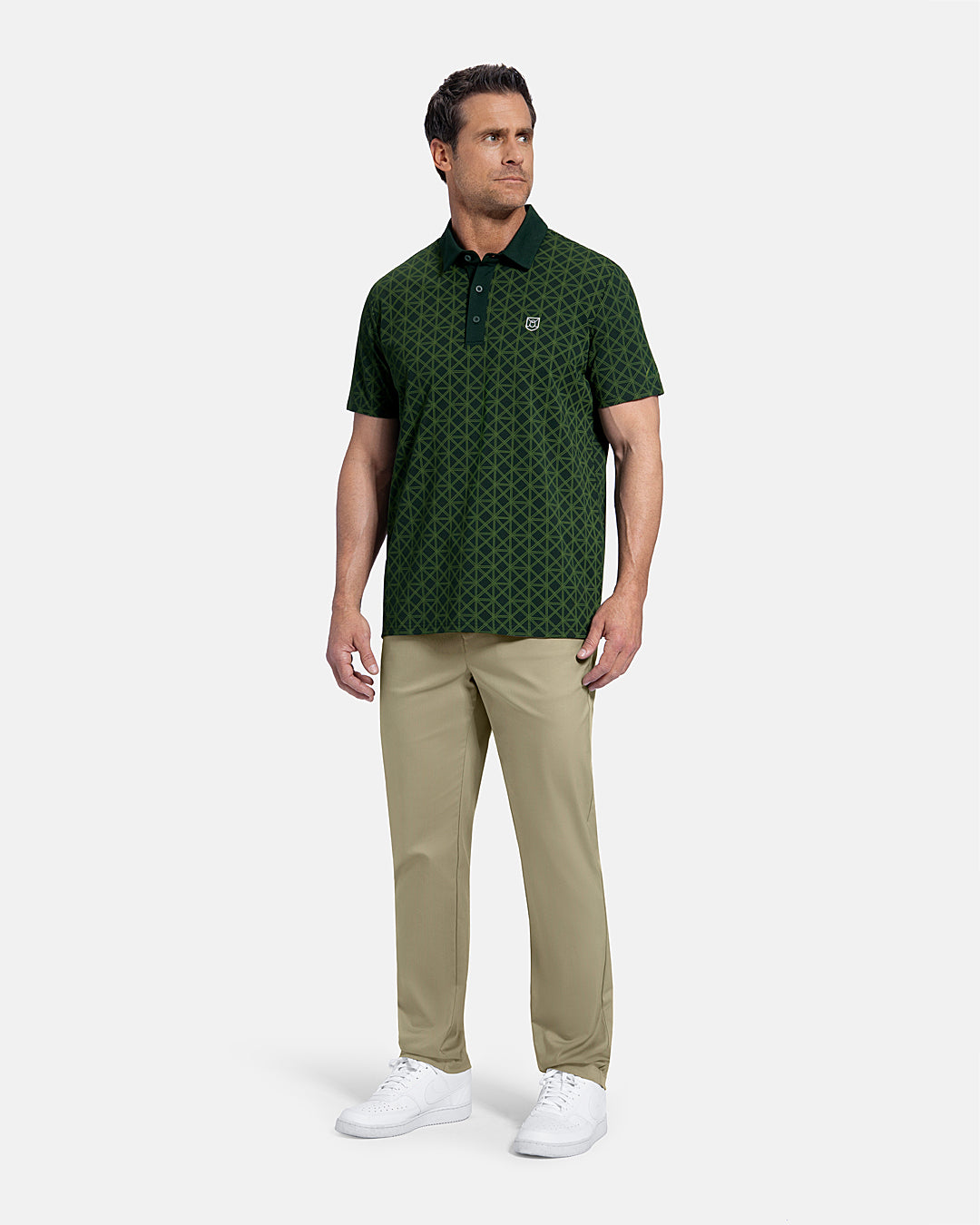 Full Body Front View of Sand Patrons Pleated Pant on white male model wearing green polo and white shoes  #color_sand