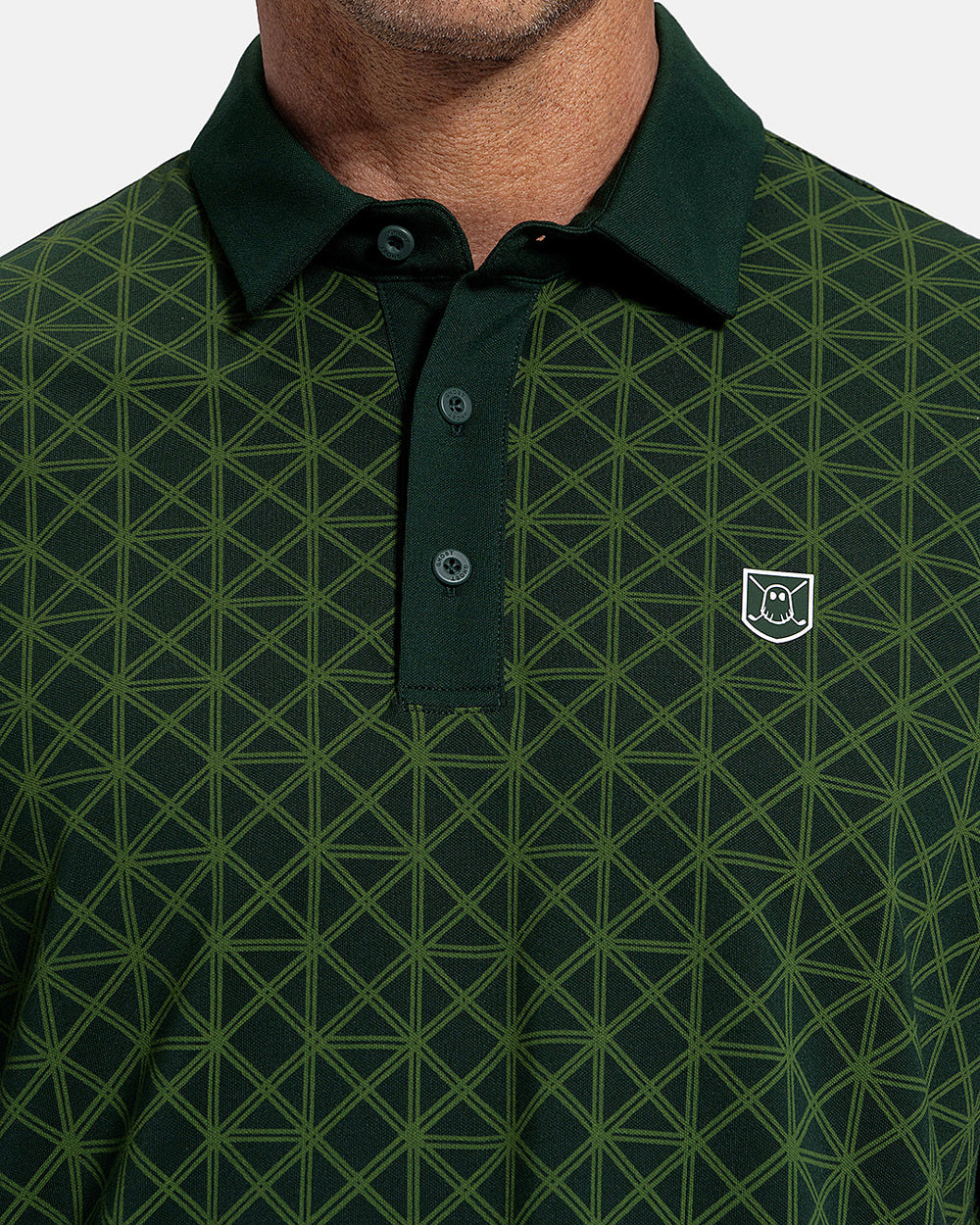 Closeup Front View of Bogey Green Patrons Printed Polo on white male model showing ghost icon graphic hit #color_bogey-green