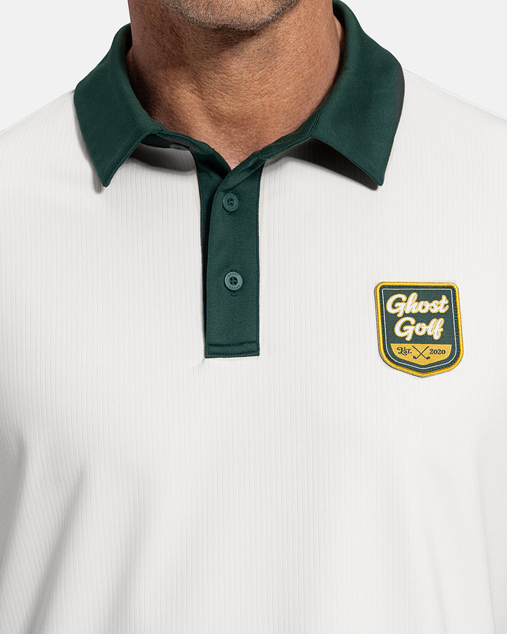 Closeup Front View of White Patrons Signature Polo on white male model showing ghost golf graphic hit #color_white