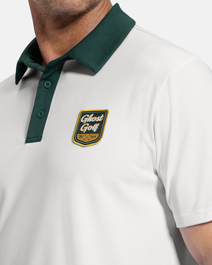 Closeup Side View of White Patrons Signature Polo on white male model showing ghost golf graphic hit #color_white