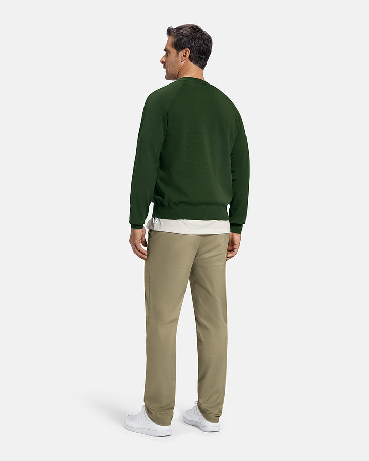 Full Body Back View of Bogey Green Patrons Sweater Cardigan on white male model wearing beige pants and white shoes #color_bogey-green