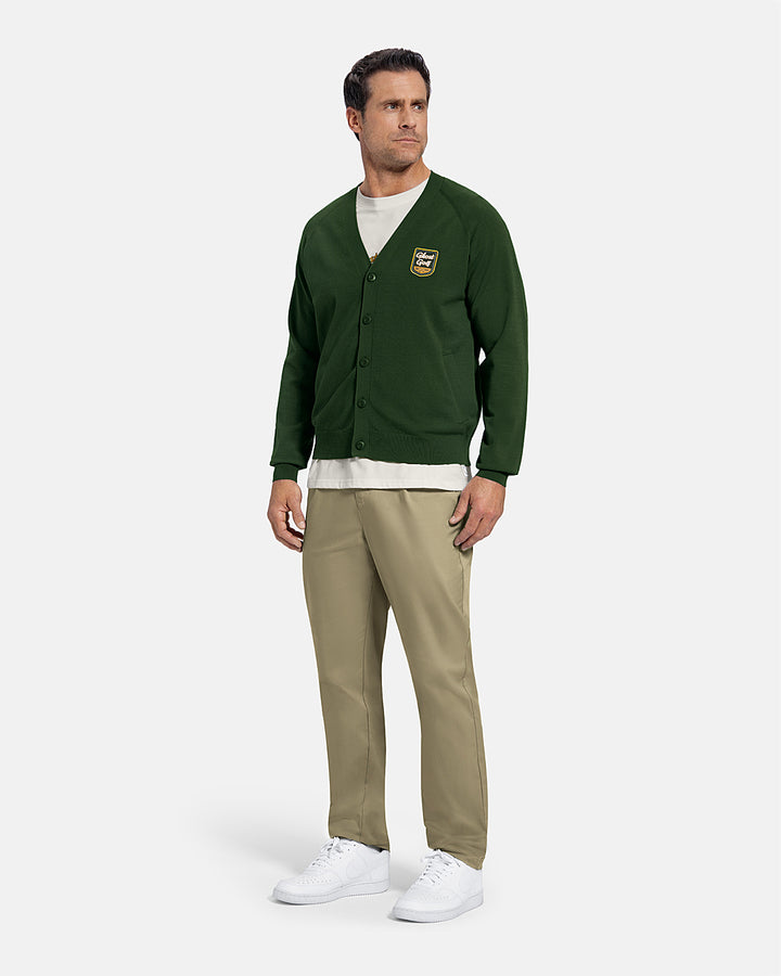 Full Body Front View of Bogey Green Patrons Sweater Cardigan on white male model wearing beige pants and white shoes and white tee #color_bogey-green