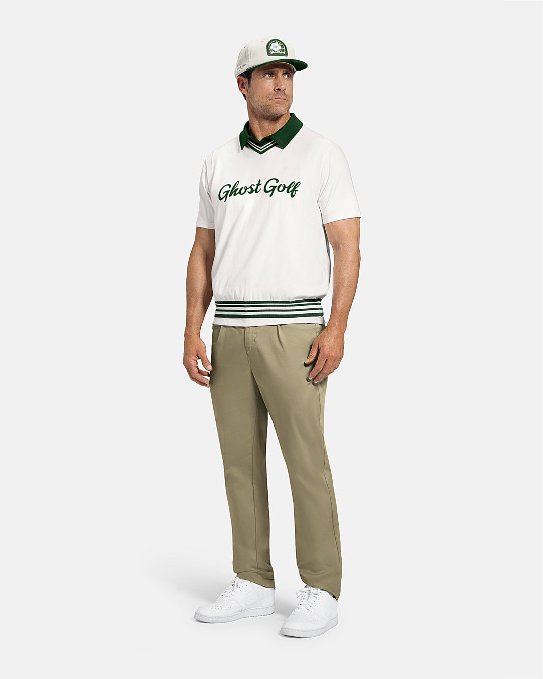 Full Body Front View of Bogey Green Patrons Sweater Cardigan on white male model wearing beige pants and white shoes and hat #color_white