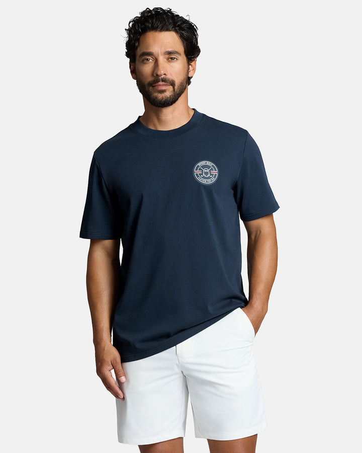 Top Front Body Shot of White Male Model Wearing Dark Navy Qualifier Fore Par Tee with white shorts #color_dark-navy