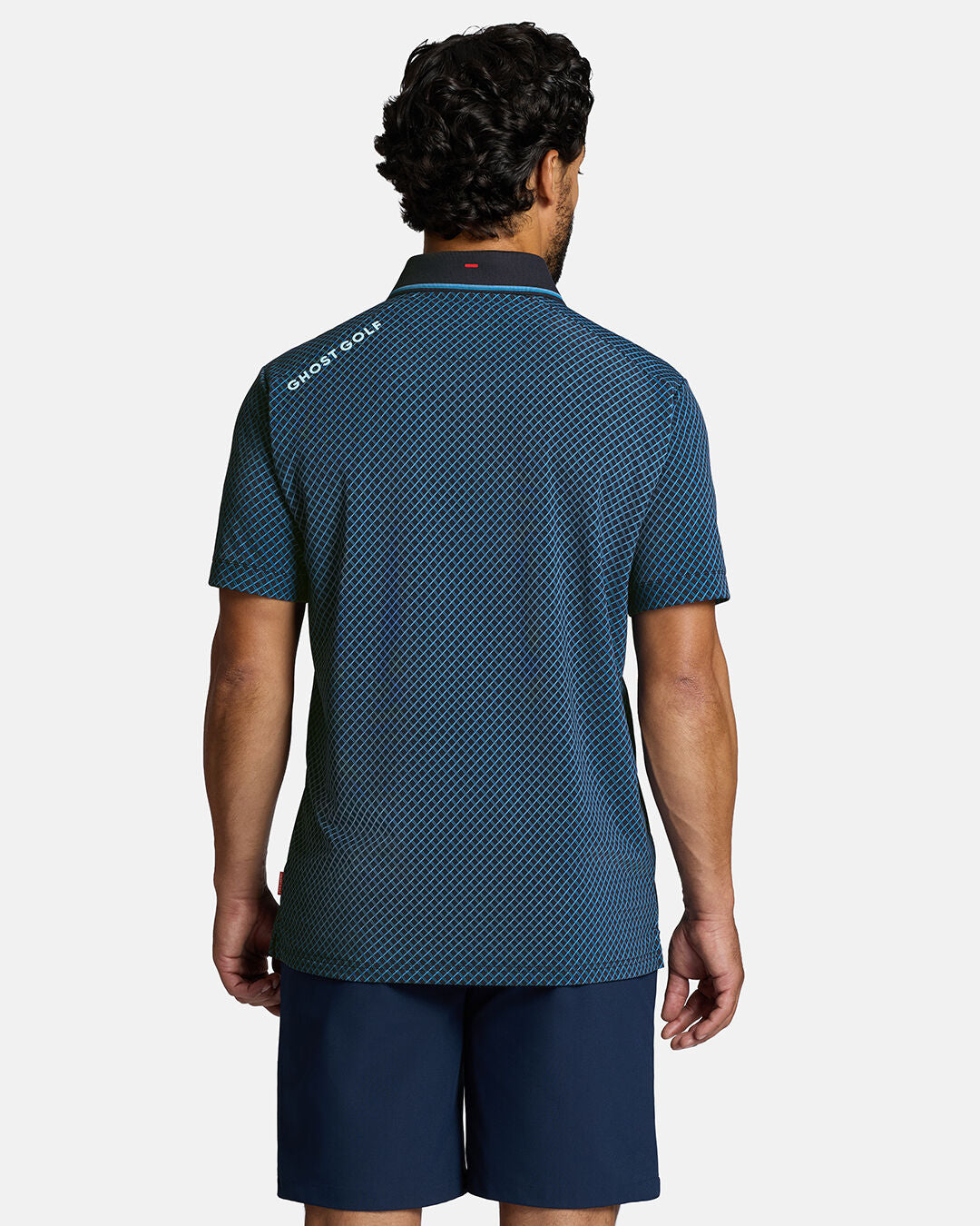 Top Back Body Shot of White Male Model Wearing Dark Navy Qualifier Chase Polo with navy shorts. Ghost Golf Hit on back left shoulder #color_dark-navy