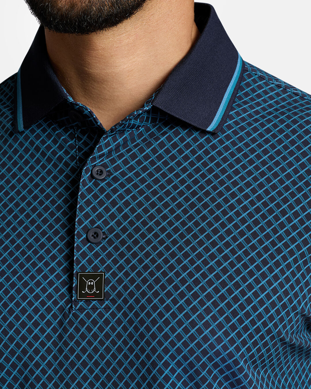 Closeup Front Shot of Dark Navy Qualifier Chase Polo showcasing buttons of polo and ghost golf icon #color_dark-navy
