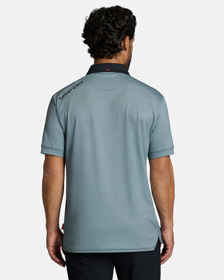 Top Back Body Shot of White Male Model Wearing Blue Qualifier Diamond Polo with black pants. Ghost Golf Hit on back left shoulder #color_blue