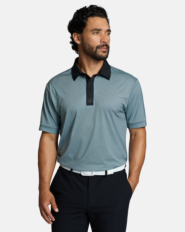 Top Front Body Shot of White Male Model Wearing Blue Qualifier Diamond Polo with black pants and white belt. Polo is tucked in pants #color_blue