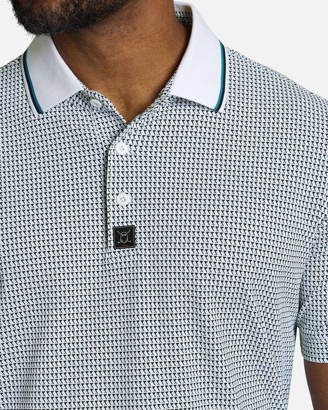 Closeup Front Shot of White Qualifier Flag Polo showcasing buttons of polo and ghost golf emblem #color_white