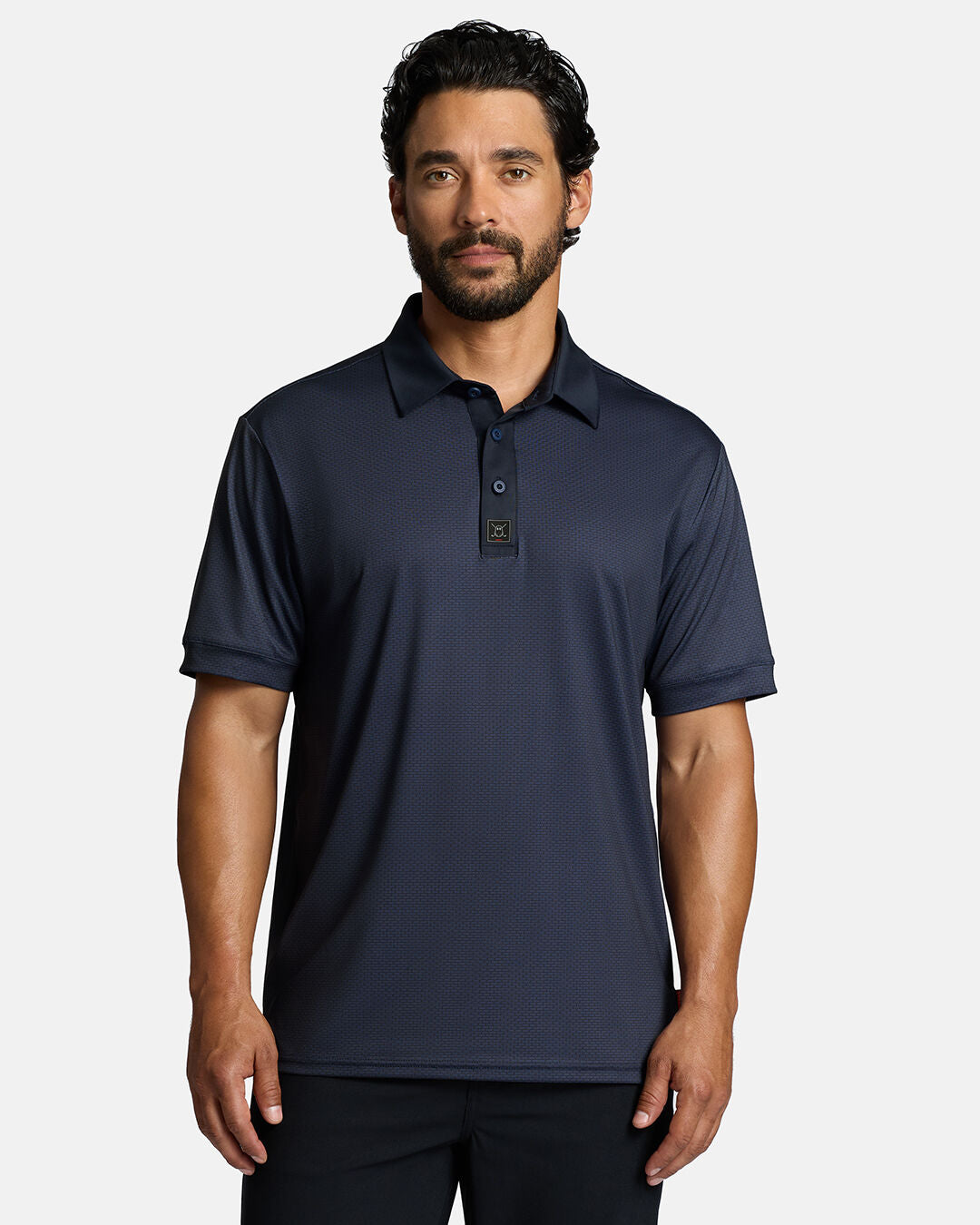 Top Front Shot of White Male Model Wearing Dark Navy Qualifier Grid Polo with polo untucked in black pants wearing #color_dark-navy