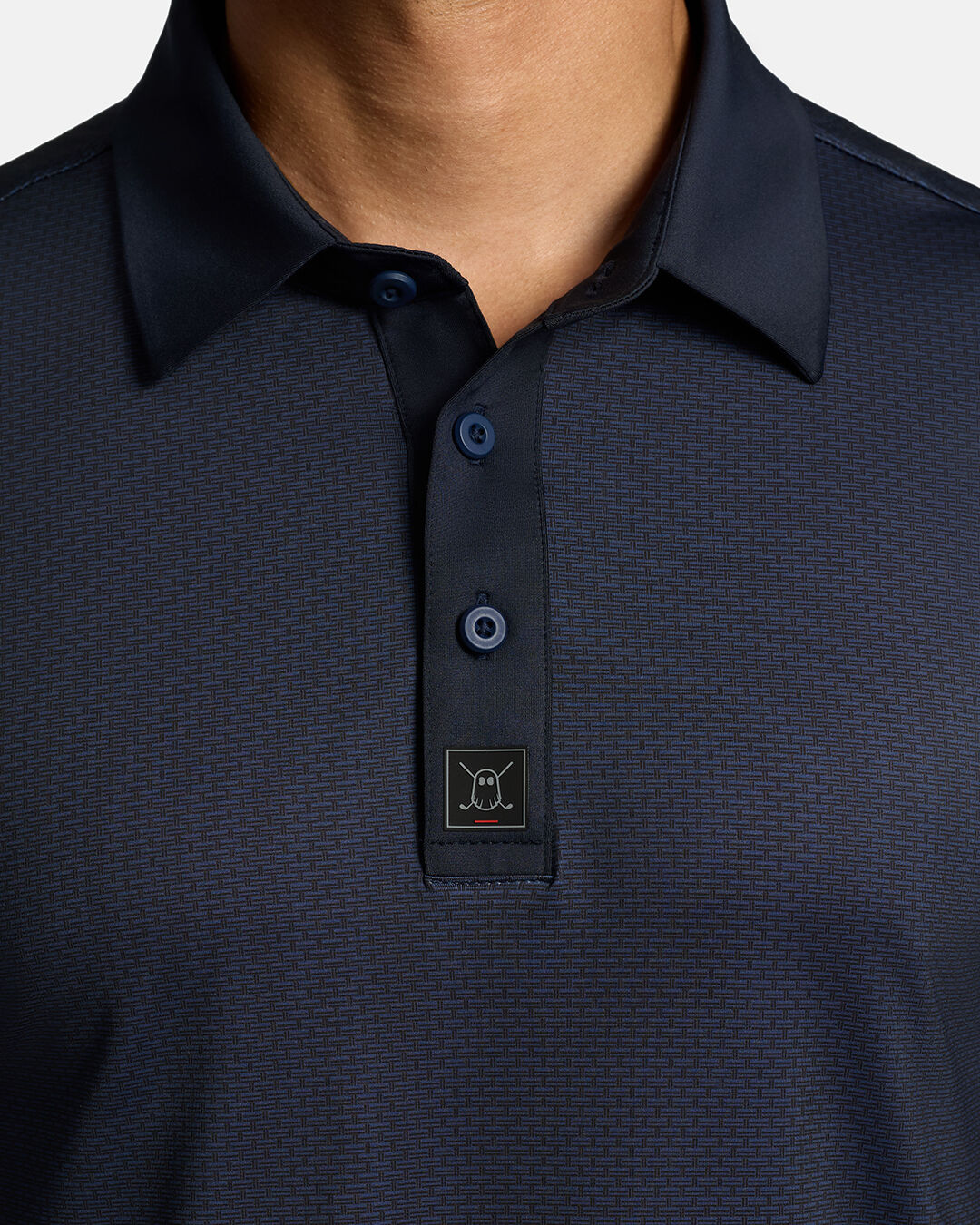 Closeup Front Shot of Dark Navy Qualifier Grid Polo showcasing buttons of polo and ghost golf icon #color_dark-navy
