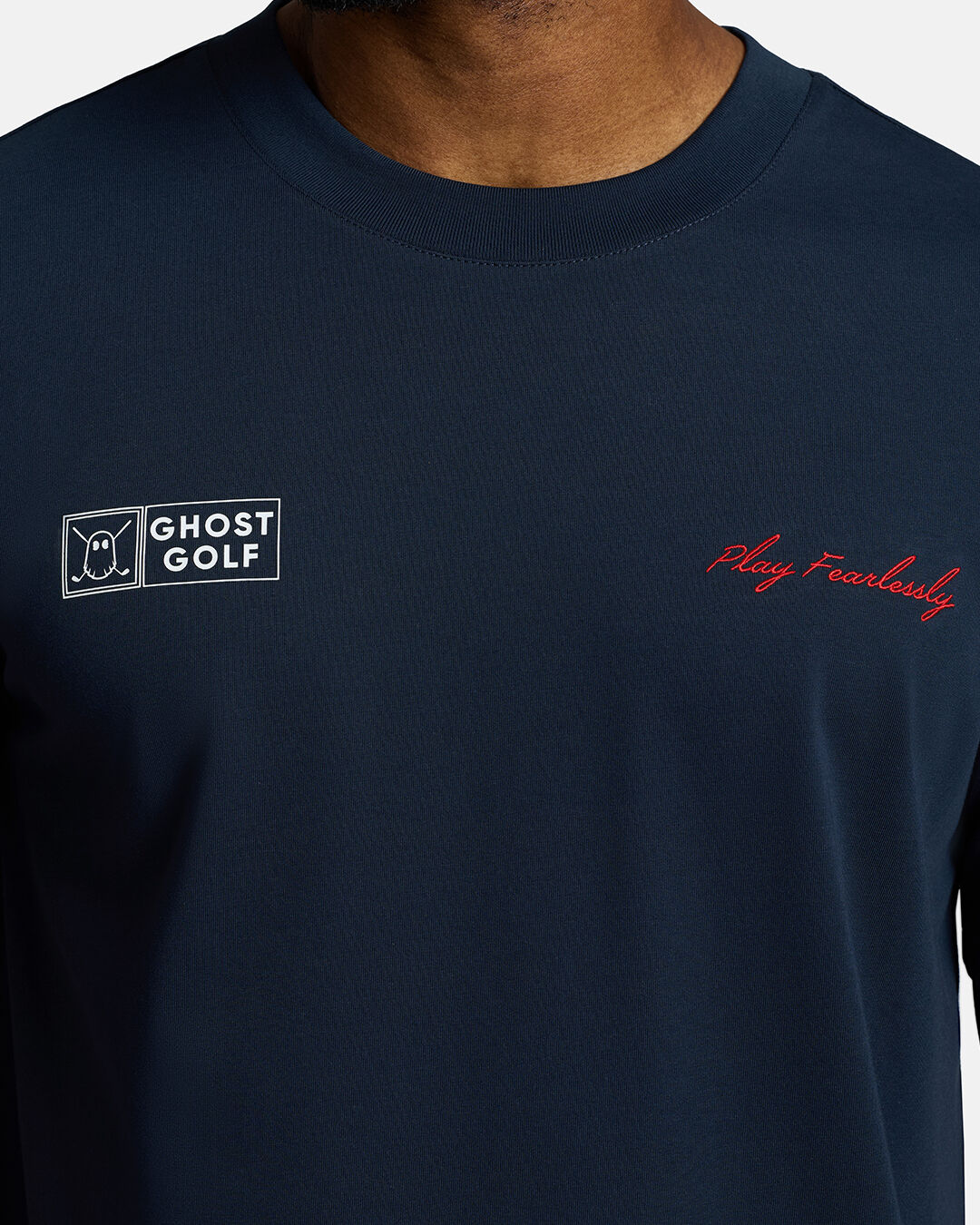 Closeup Shot of Dark Navy Qualifier Player Tee showcasing play fearlessly on left chest and ghost golf on right on chest #color_dark-navy