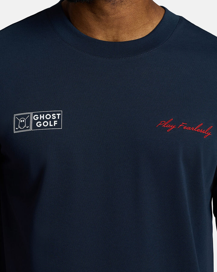 Closeup Shot of Dark Navy Qualifier Player Tee showcasing play fearlessly on left chest and ghost golf on right on chest #color_dark-navy