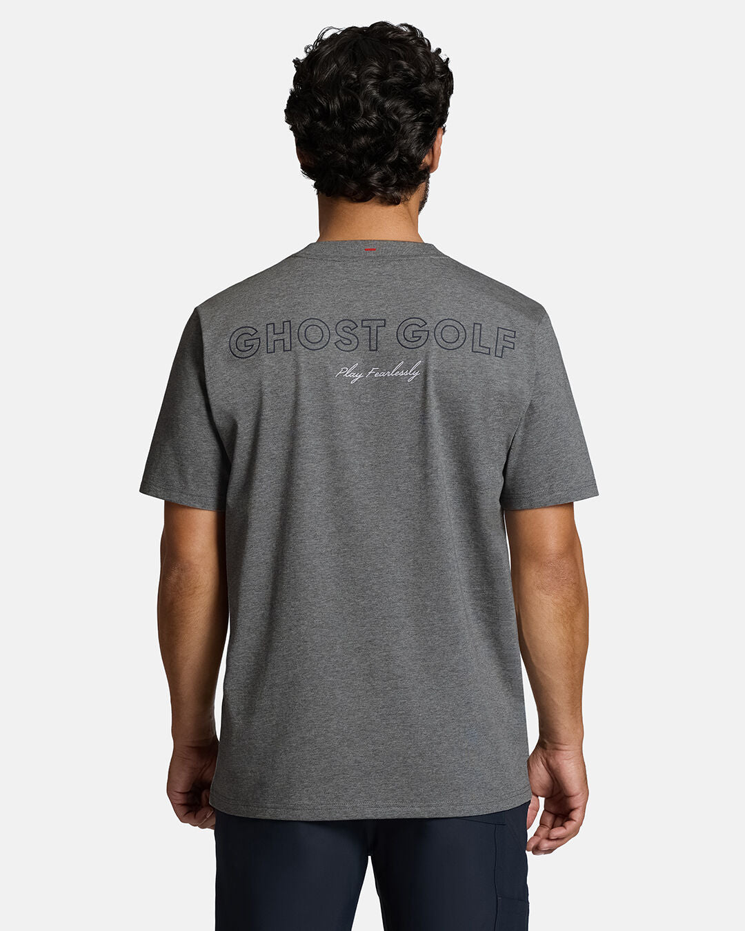 Top Back Body Shot of White Male Model Wearing Grey Qualifier Player Tee show casing typographic design on the back. Model is wearing navy pants #color_heather-grey