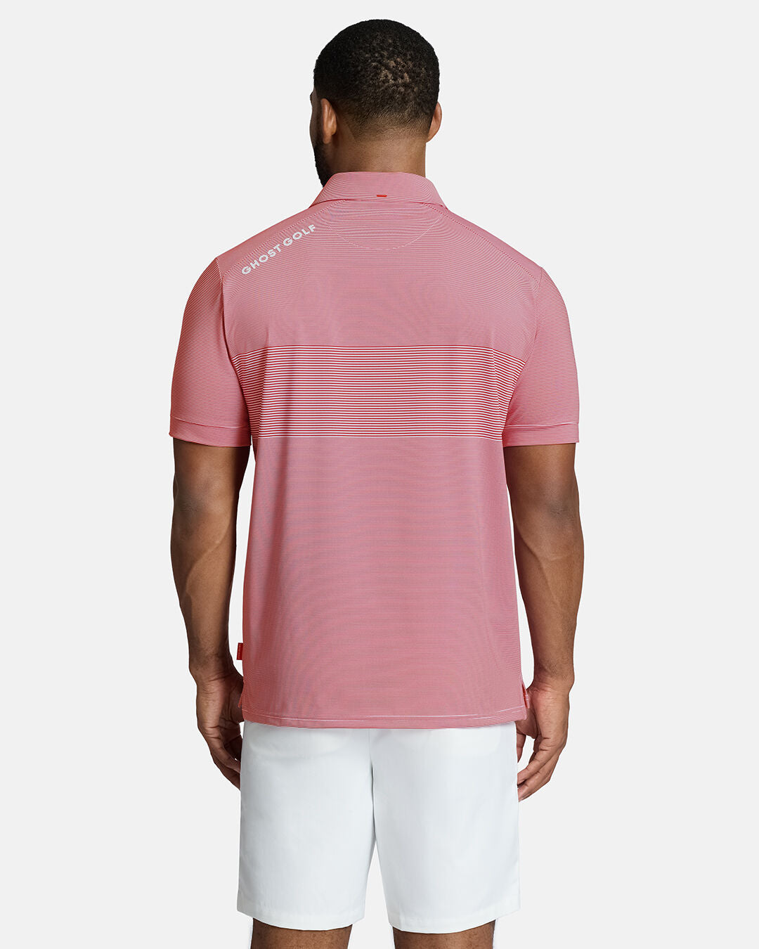 Top Back Body Shot of Black Male Model Wearing Red Qualifier Stripe Polo with white shorts. Ghost Golf Hit on back left shoulder #color_red