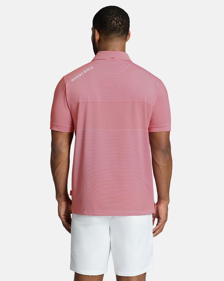Top Back Body Shot of Black Male Model Wearing Red Qualifier Stripe Polo with white shorts. Ghost Golf Hit on back left shoulder #color_red