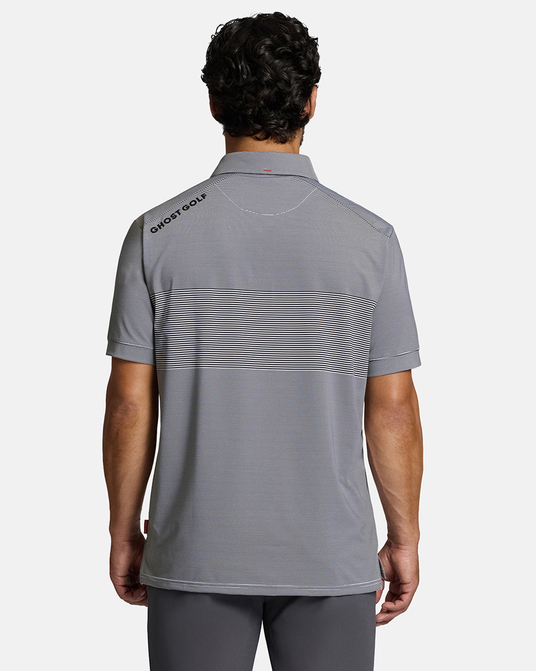 Top Back Body Shot of White Male Model Wearing Grey Qualifier Stripe Polo with grey pants. Ghost Golf Hit on back left shoulder #color_dark-navy
