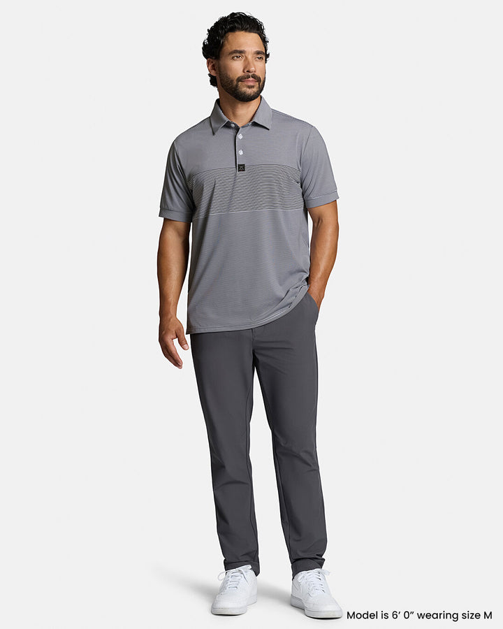 Full Front Body Shot of Dark Navy Male Model Wearing Grey Qualifier Stripe Polo with grey pants and white shoes #color_dark-navy