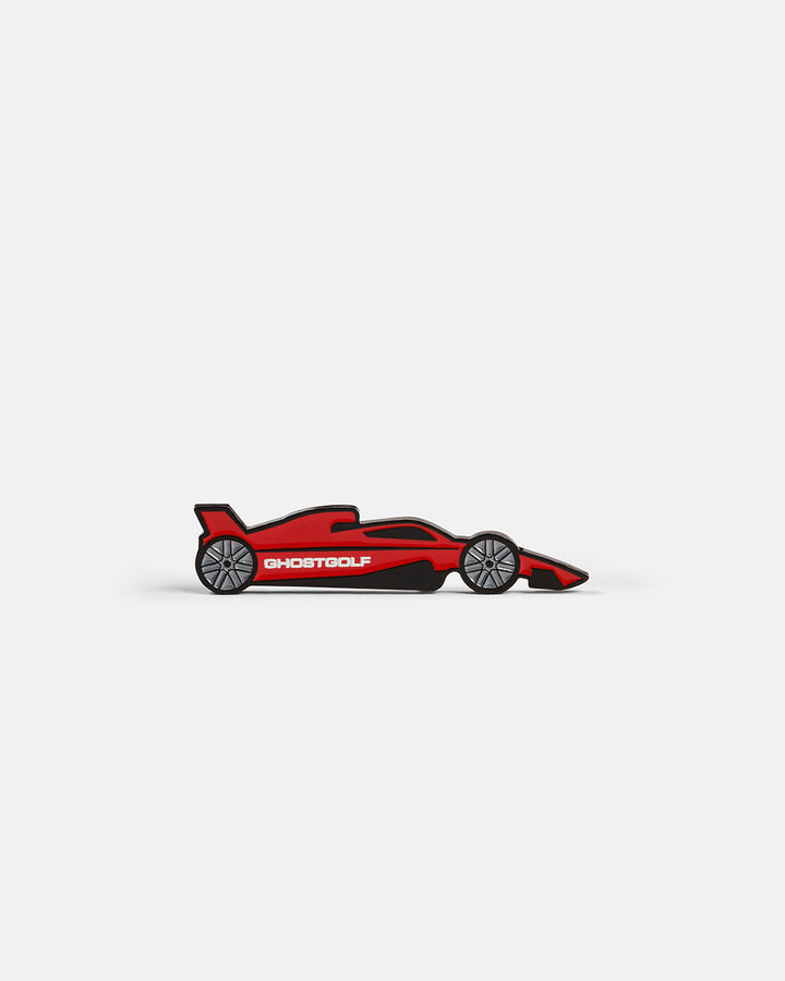 Product photo of a ball marker featuring a red racing car with “Ghost Golf” displayed on the side.