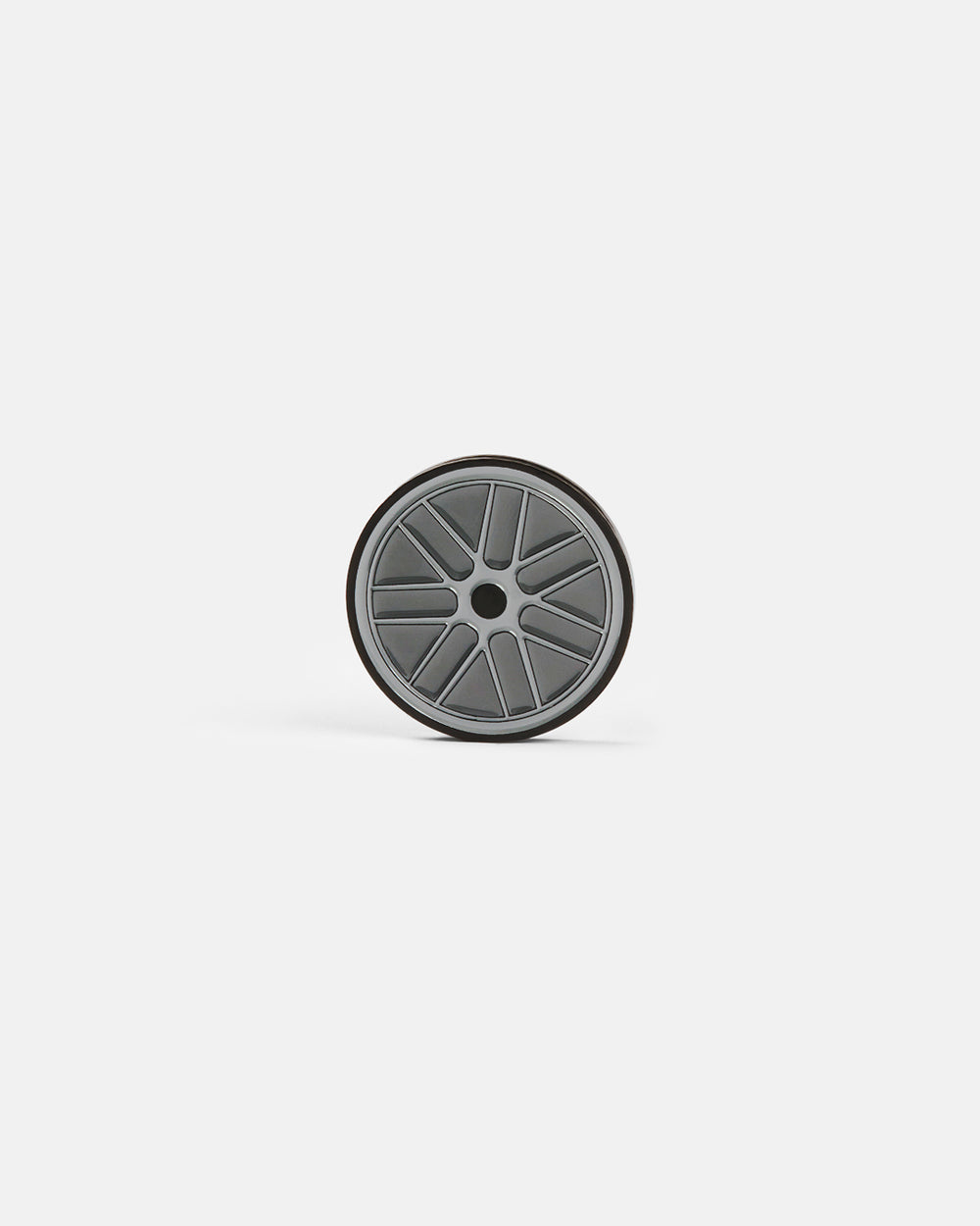 Product photo of a circular ball marker featuring a racing wheel design.