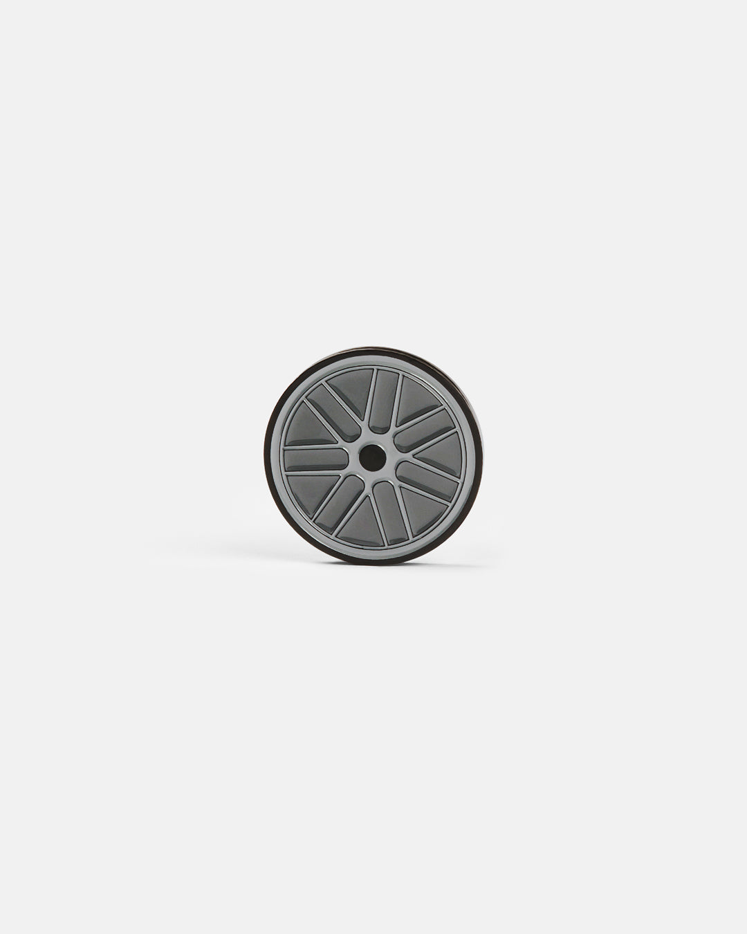 Product photo of a circular ball marker featuring a racing wheel design.