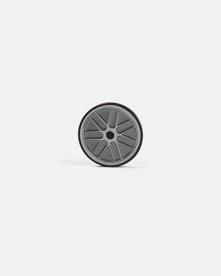 Product photo of a circular ball marker featuring a racing wheel design.