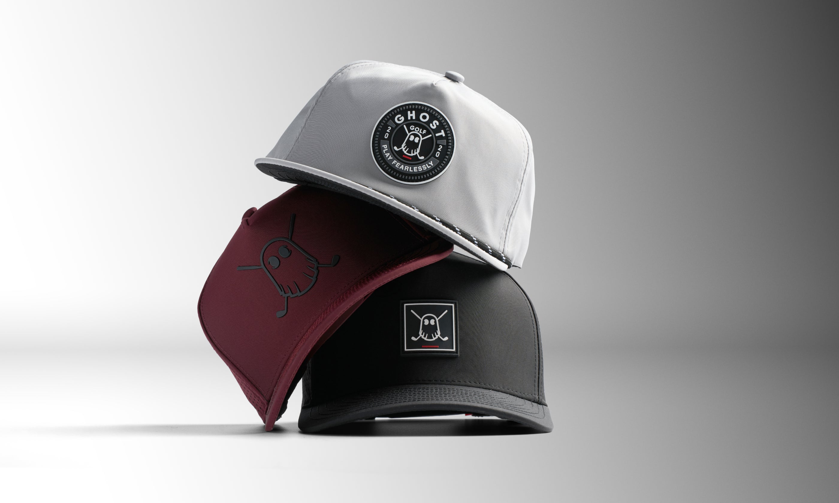 Front studio shot of three Ghost Golf hats stacked on top of one another