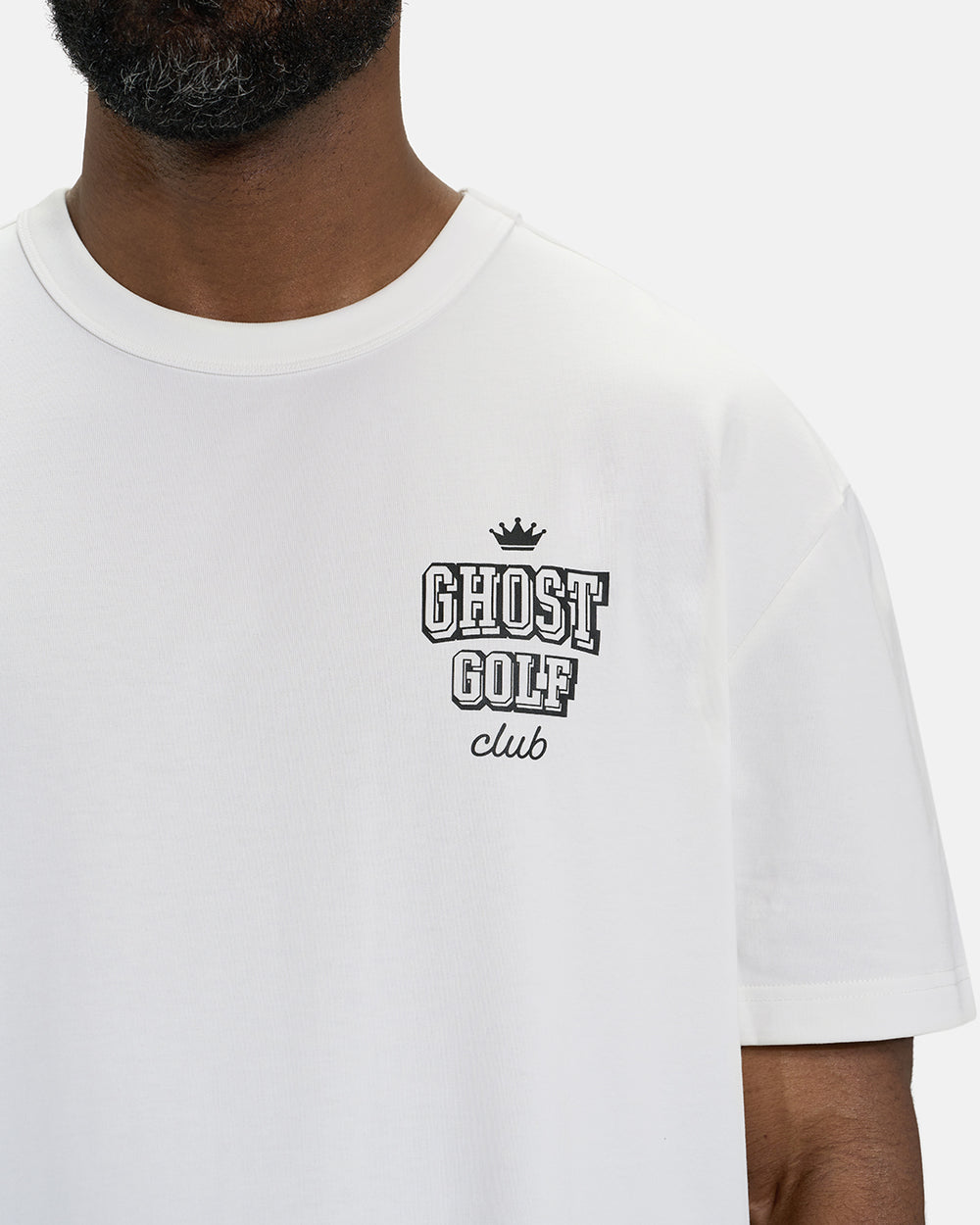 Front Closeup View of White Spectator Club Tee on Black Male Model with Ghost Golf #color_white