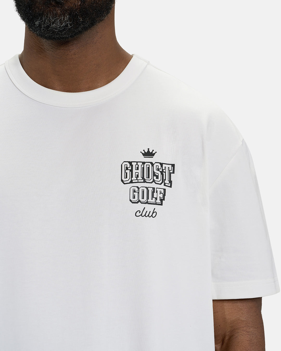 Front Closeup View of White Spectator Club Tee on Black Male Model with Ghost Golf #color_white