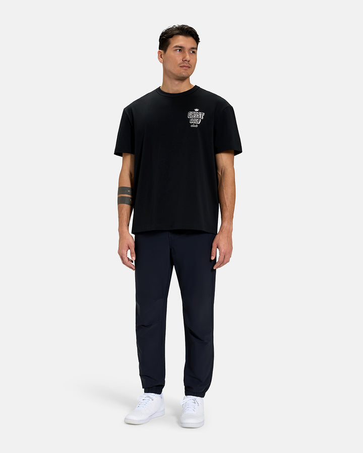 Full Body Front View of Black Spectator Club Tee on Asian Male Model wearing navy pants and white shoes #color_black