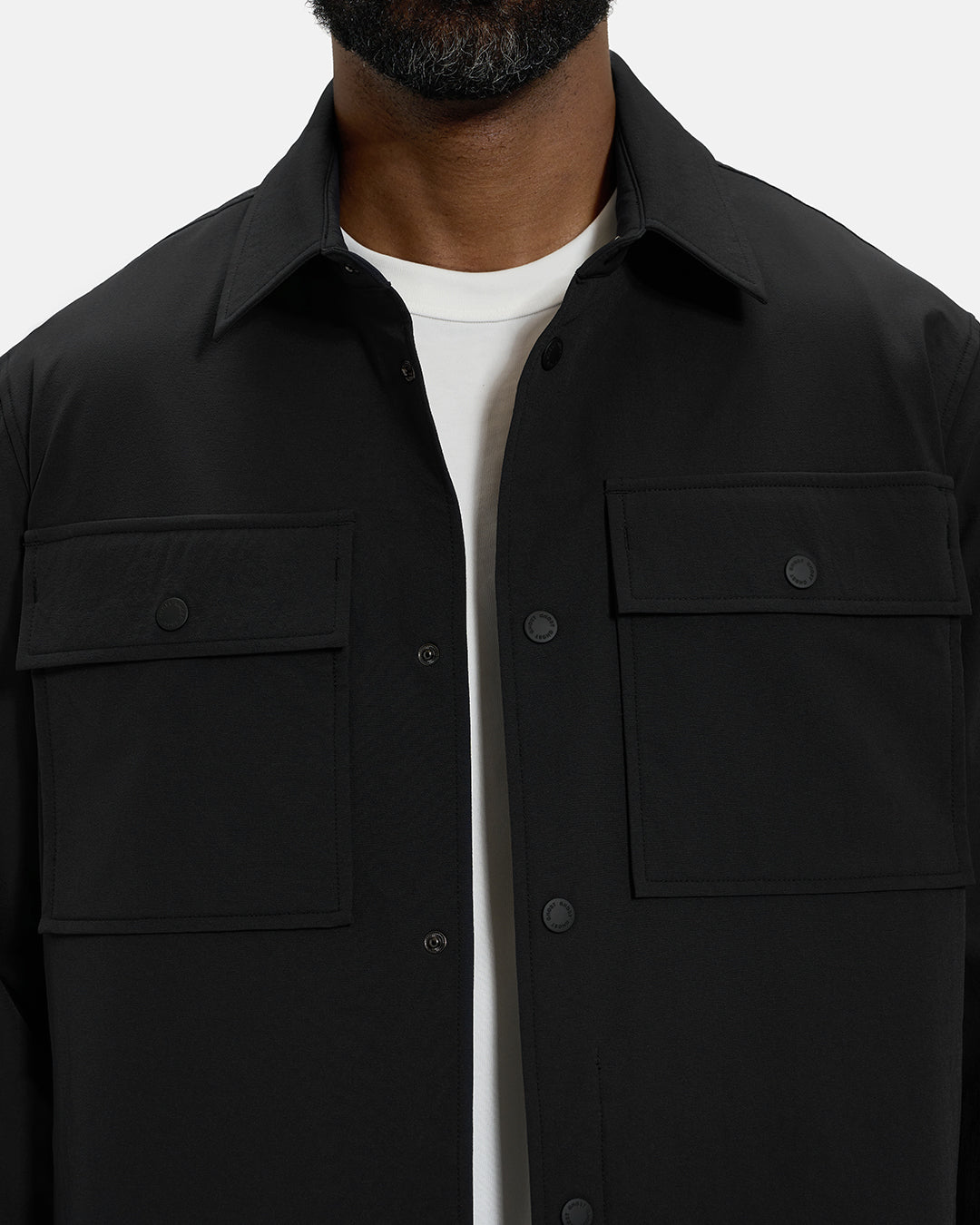 Front Closeup View of Black Spectator Collared Shirt Jacket on Black Male Model with Ghost Golf #color_black