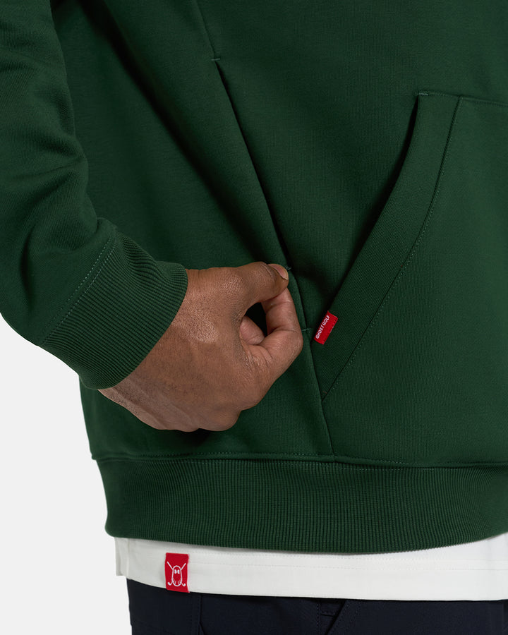 Side Closeup View of Bogey Green Spectator Dormie Hoodie on Black Male Model pulling on zipper #color_bogey-green