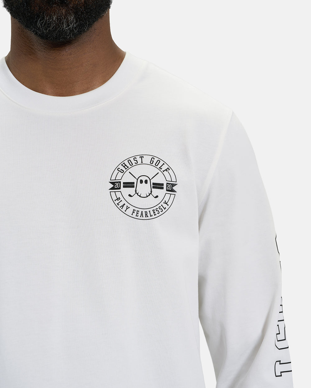Front Closeup View of White Spectator Long Sleeve Tee on Black Male Model with Ghost Golf #color_white