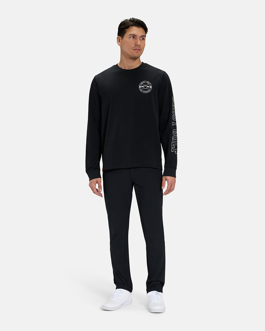 Full Body Front View of Black Spectator Long Sleeve Tee on Asian Male Model wearing black pants and white shoes #color_black