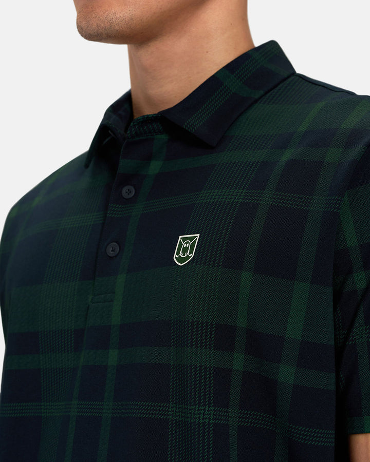 Front Closeup View of Bogey Green Spectator Plaid Polo on Asian Male Model with Ghost Icon Crest #color_bogey-green