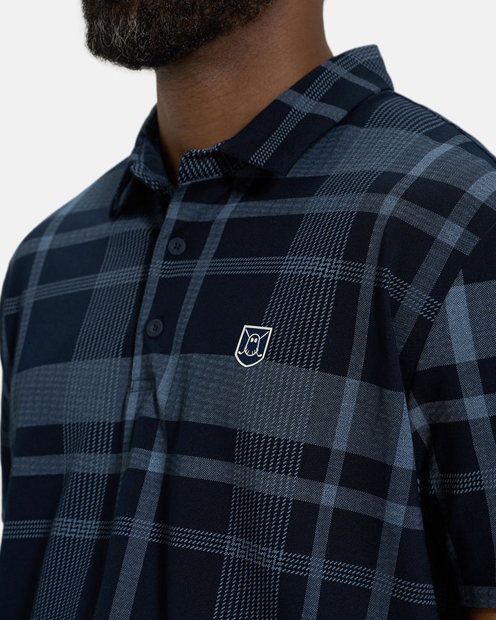Front Closeup View of Navy Spectator Plaid Polo on Black Male Model with Ghost Icon Crest #color_navy