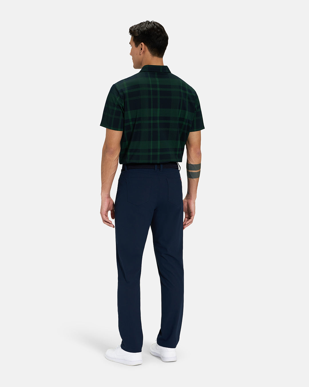 Full Body Back View of Bogey Green Spectator Plaid Polo Tucked on Asian Male Model wearing navy pants black belt and white shoes #color_bogey-green