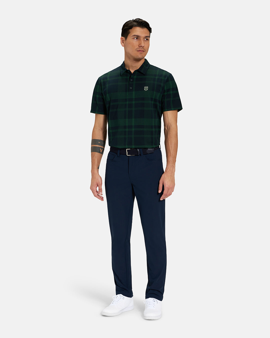 Full Body Front View of Bogey Green Spectator Plaid Polo Tucked on Asian Male Model wearing navy pants black belt and white shoes #color_bogey-green