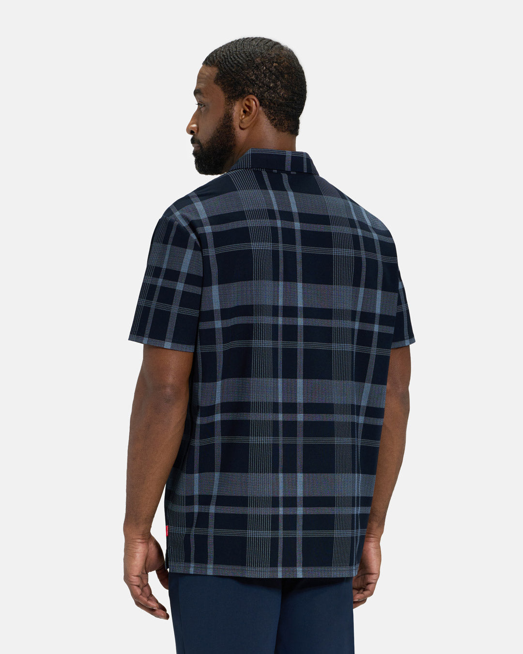 Back View of Navy Spectator Plaid Polo on Black Male Model #color_navy