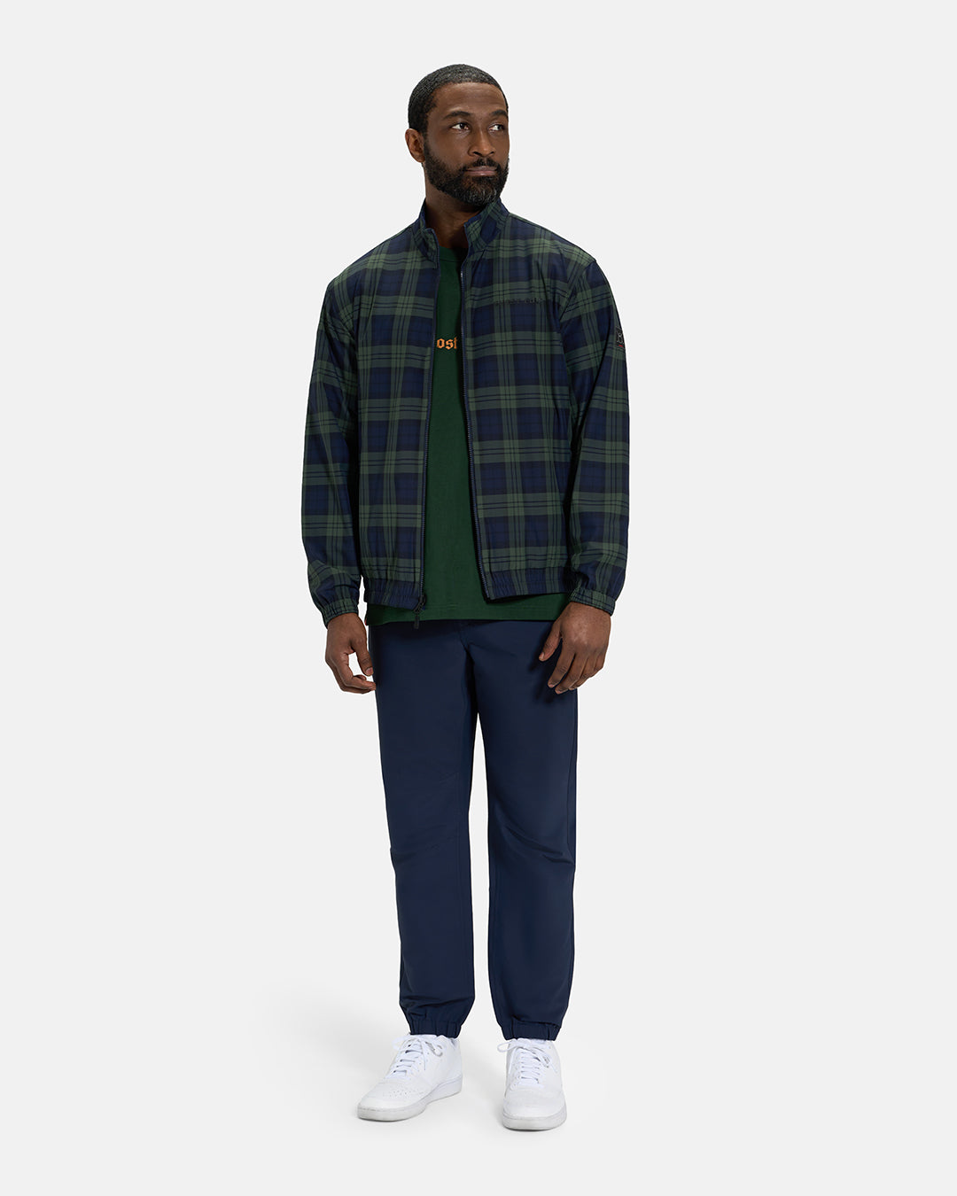 Full Body View of Plaid Dark Navy Spectator Reversible Jacket on Black Male Model wearing forest green tee navy joggers and white shoes #color_plaid-navy