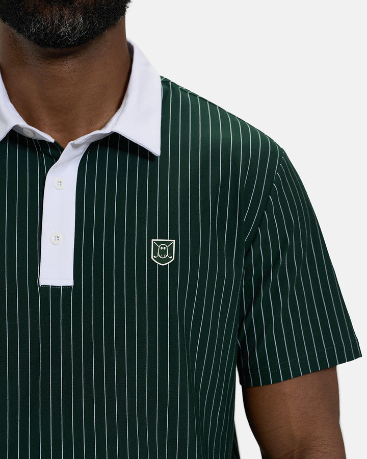 Front Closeup View of Bogey Green Spectator Stripe Polo on Black Male Model with Ghost Icon Crest #color_bogey-green