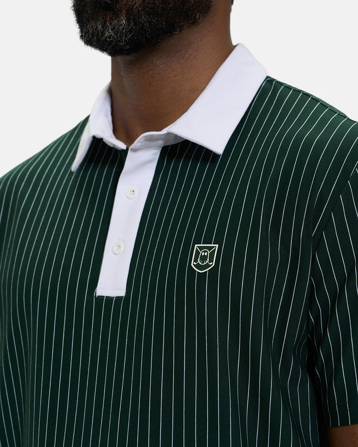 Front Closeup View of Bogey Green Spectator Stripe Polo on Black Male Model with Ghost Icon Crest #color_bogey-green