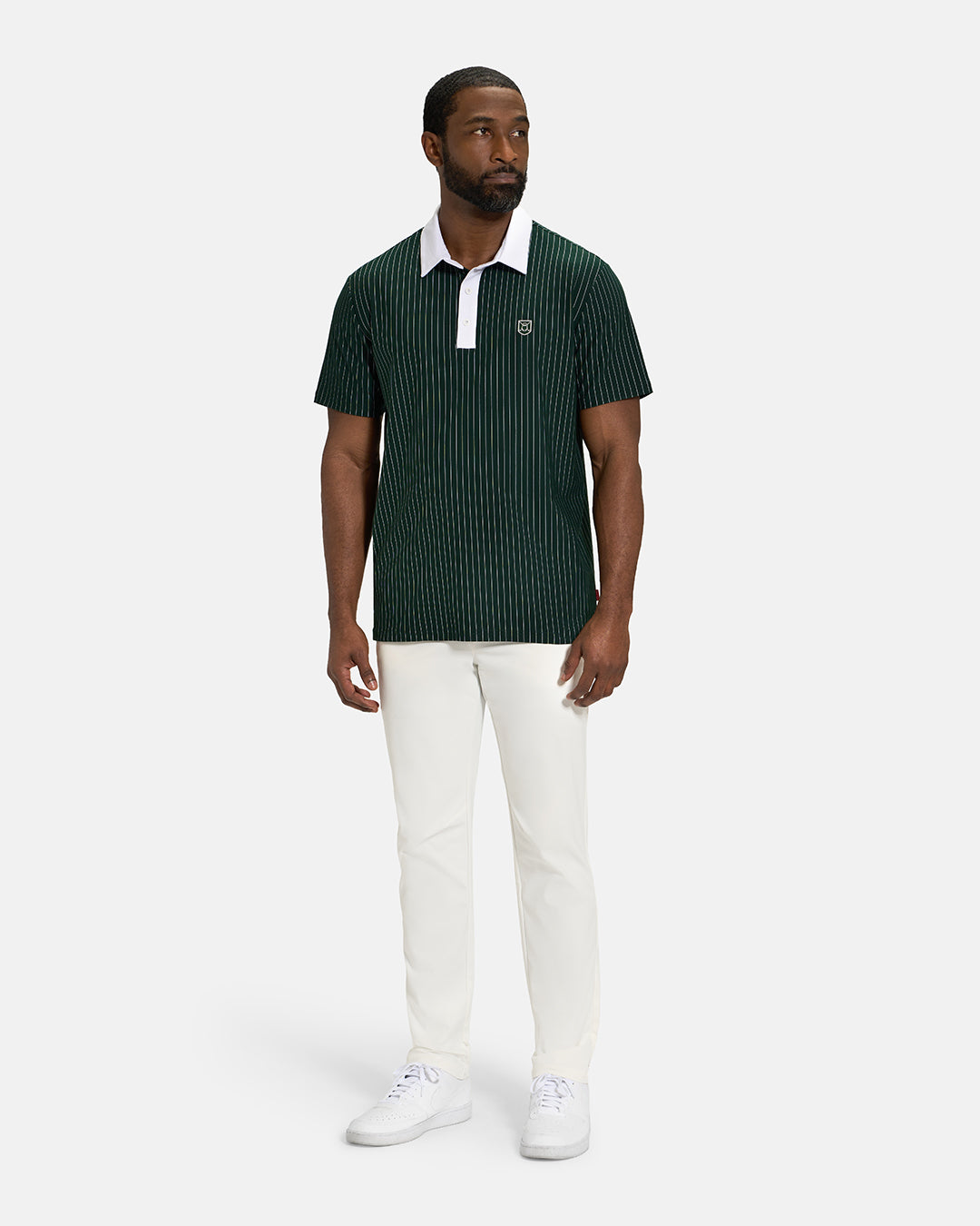 Full Body View of Bogey Green Spectator Stripe Polo on Black Male Model wearing white pants and white shoes #color_bogey-green