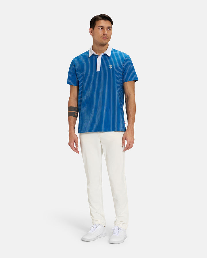 Full Body Front View of Royal Blue Spectator Stripe Polo Tucked on Asian Male Model wearing white pants and white shoes #color_royal-blue